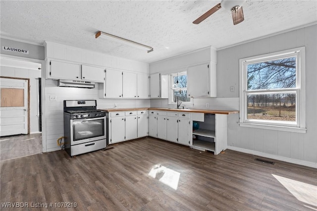 kitchen featuring white cabinets, stainless steel range with gas stovetop, and dark wood finished floors