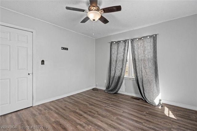 empty room featuring a ceiling fan, a textured ceiling, baseboards, and wood finished floors