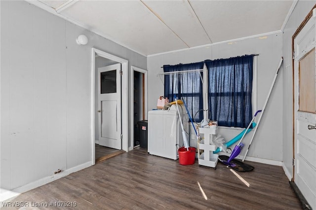 interior space with baseboards, wood finished floors, washer / dryer, and crown molding