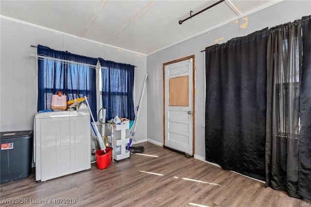 washroom with laundry area, wood finished floors, and baseboards