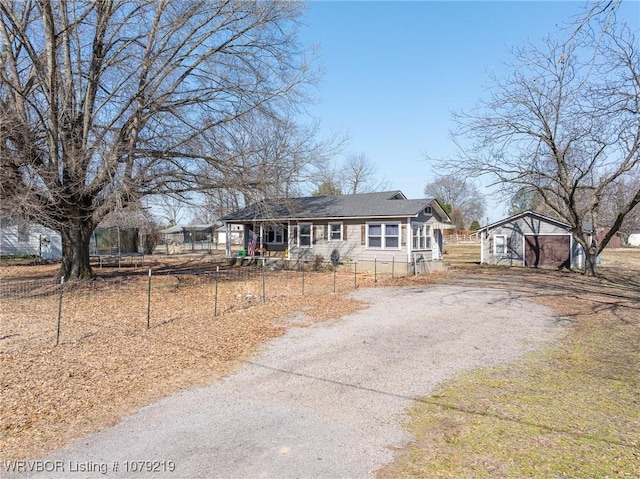 view of front of house with a fenced front yard and aphalt driveway