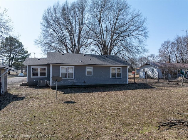 rear view of house featuring fence