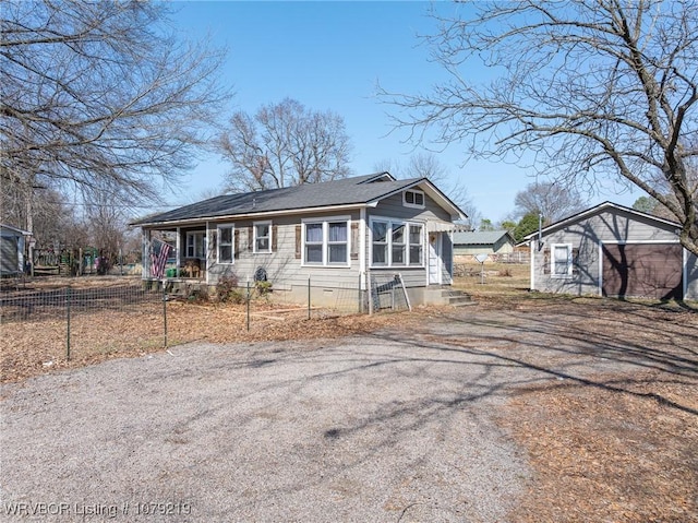 view of front of property with crawl space, fence, and an outdoor structure