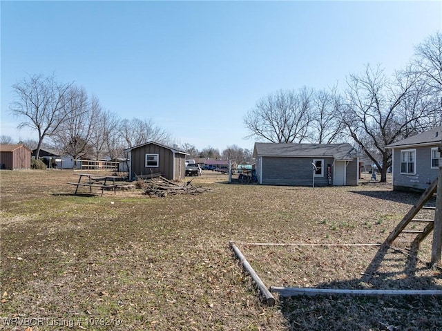 view of yard featuring a storage shed and an outdoor structure