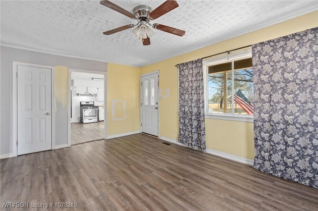 unfurnished room featuring ornamental molding, a textured ceiling, baseboards, and wood finished floors