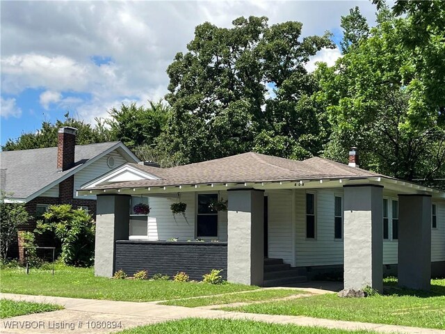 808 S 23rd St, Fort Smith, AR 72901 - view of front of home with roof with shingles, a porch, and a front yard