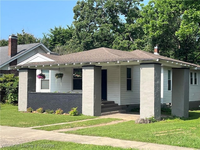 808 S 23rd St, Fort Smith, AR 72901 - view of front of home featuring a front yard, covered porch, a shingled roof, and brick siding