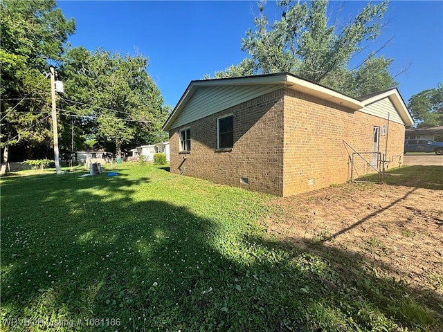 1117 W Creek Ave, Sallisaw, OK 74955 - view of home's exterior with crawl space, brick siding, and a yard