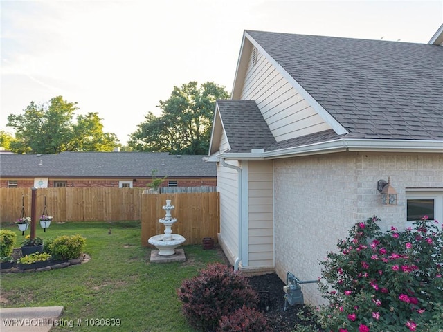 2808 May Branch Pt, Fort Smith, AR 72903 - view of side of home featuring roof with shingles, fence, and a lawn