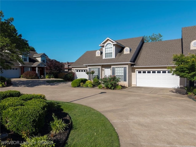 2808 May Branch Pt, Fort Smith, AR 72903 - cape cod house featuring an attached garage, driveway, and roof with shingles