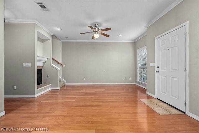 2808 May Branch Pt, Fort Smith, AR 72903 - unfurnished living room featuring light wood-type flooring, a ceiling fan, ornamental molding, and stairs
