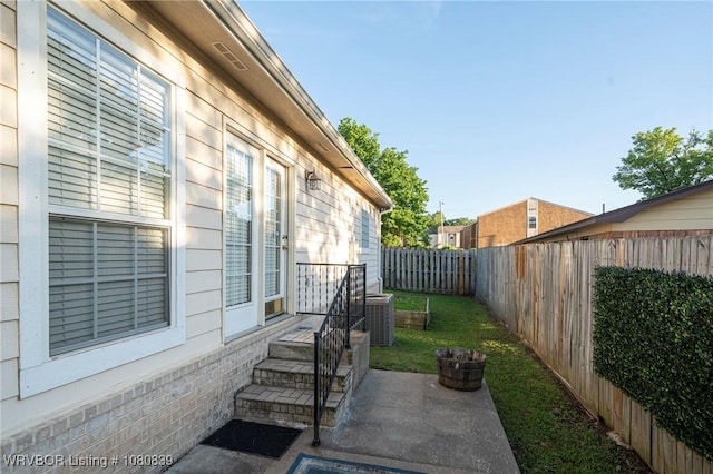 2808 May Branch Pt, Fort Smith, AR 72903 - view of property exterior featuring a fenced backyard, central AC, and a lawn