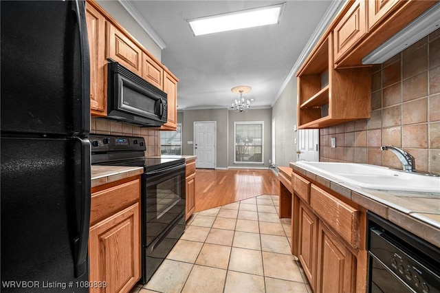 2808 May Branch Pt, Fort Smith, AR 72903 - kitchen featuring an inviting chandelier, crown molding, black appliances, light countertops, and tasteful backsplash