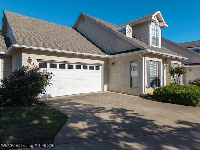 2808 May Branch Pt, Fort Smith, AR 72903 - view of front facade featuring driveway, brick siding, a shingled roof, and an attached garage