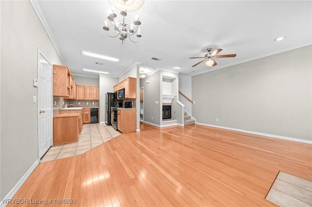 2808 May Branch Pt, Fort Smith, AR 72903 - unfurnished living room with crown molding, light wood-style floors, ceiling fan with notable chandelier, and stairs