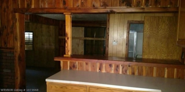 kitchen featuring wooden walls