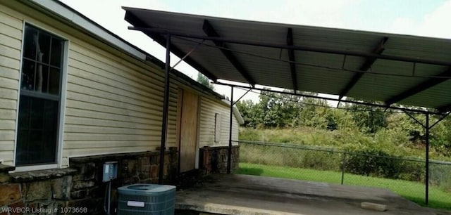 view of property exterior with a carport and cooling unit