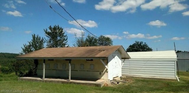 back of property featuring a lawn