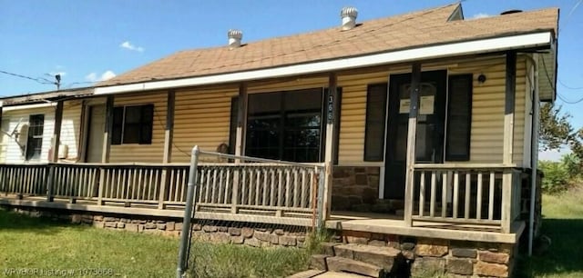 rear view of property with a porch