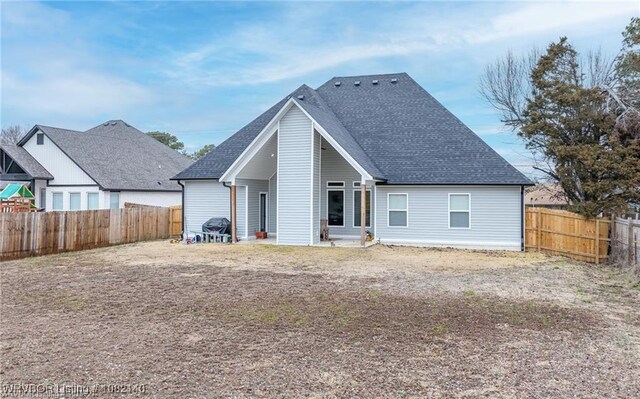 2205 Moody Rd, Barling, AR 72923 - back of property featuring a shingled roof and a fenced backyard