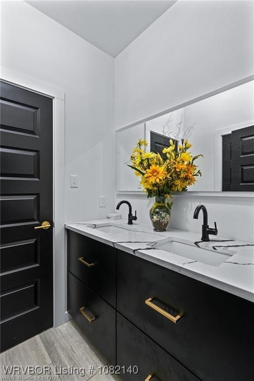 2205 Moody Rd, Barling, AR 72923 - bathroom featuring double vanity and wood finished floors
