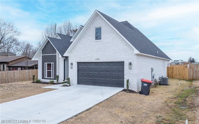 2205 Moody Rd, Barling, AR 72923 - view of front facade featuring brick siding, roof with shingles, a garage, and driveway