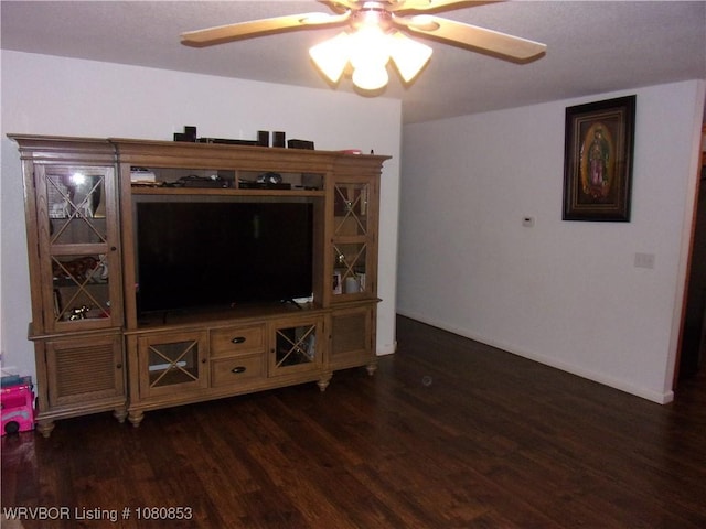 living area with dark wood finished floors, baseboards, and a ceiling fan