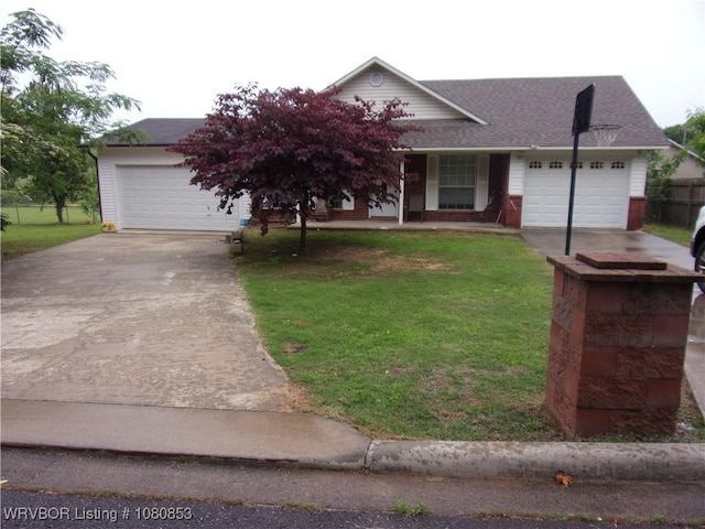 view of front of property featuring concrete driveway, brick siding, a front lawn, and an attached garage
