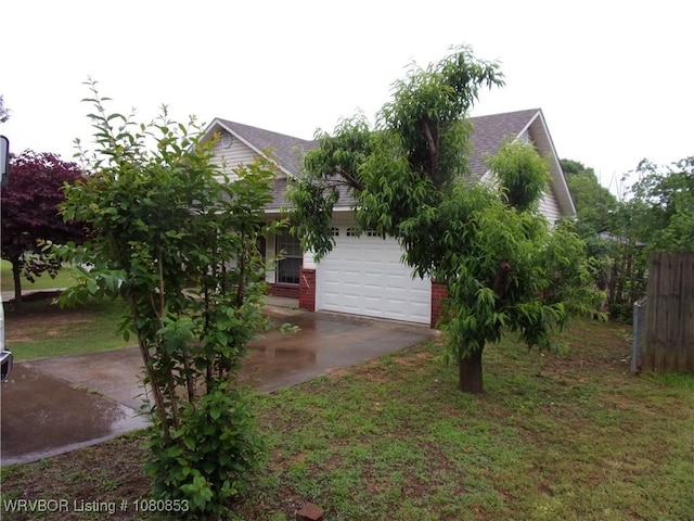 exterior space with driveway, brick siding, roof with shingles, and a garage