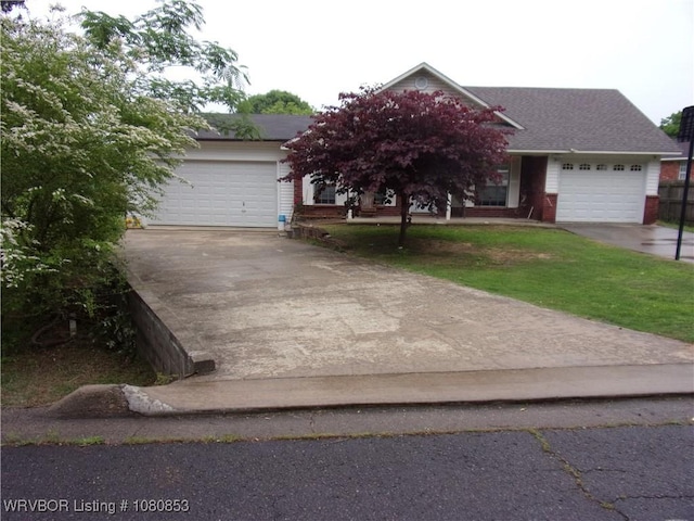 view of front of home featuring concrete driveway and a garage