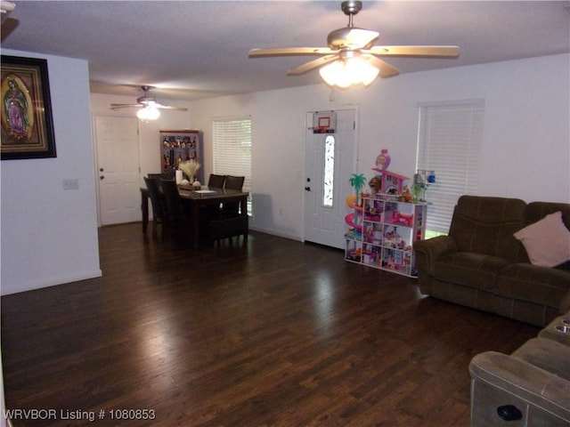 living room with wood finished floors, baseboards, and ceiling fan
