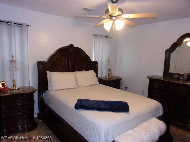 bedroom with a ceiling fan, visible vents, and tile patterned floors
