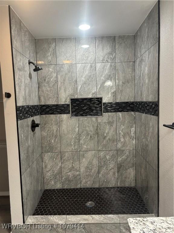 full bathroom with tiled shower