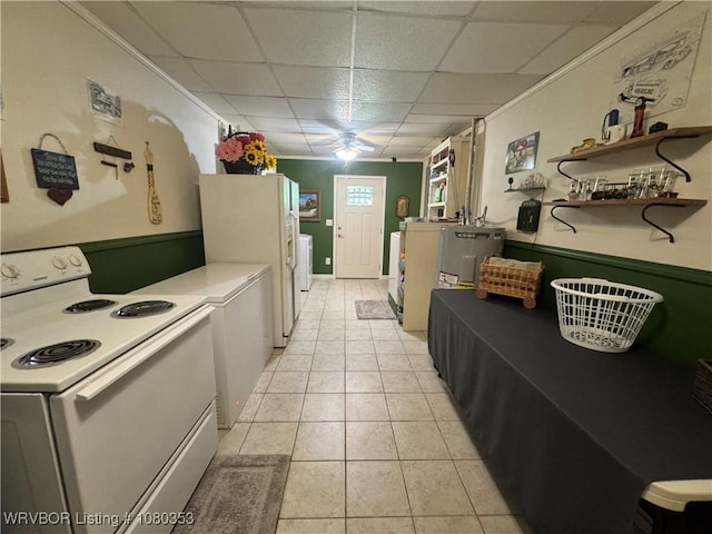 6538 110th Rd, Red Oak, OK 74563 - kitchen featuring a drop ceiling, white appliances, light tile patterned floors, ceiling fan, and washing machine and dryer