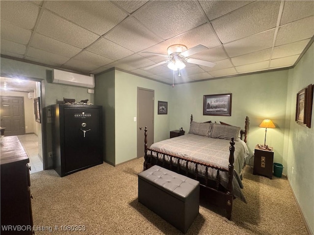6538 110th Rd, Red Oak, OK 74563 - bedroom with a wall mounted AC, a drop ceiling, light colored carpet, and a ceiling fan
