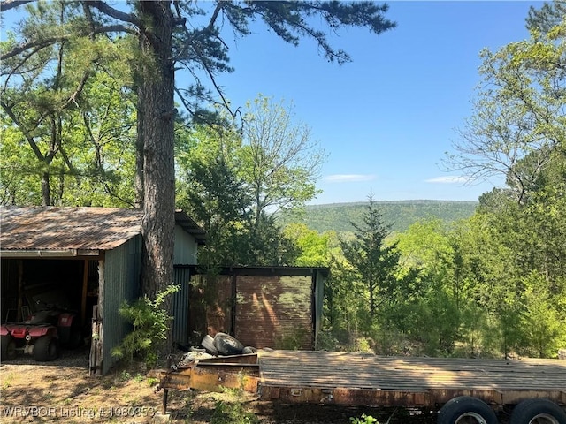 6538 110th Rd, Red Oak, OK 74563 - exterior space featuring an outdoor structure and a view of trees