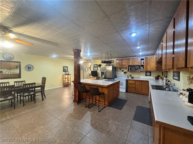 6538 110th Rd, Red Oak, OK 74563 - kitchen with light countertops, brown cabinetry, stainless steel appliances, and a sink
