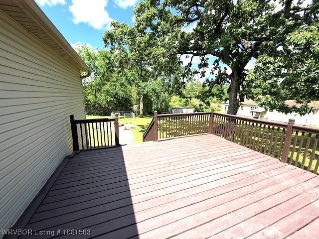 1434 W College St, Ozark, AR 72949 - deck featuring view of wooded area