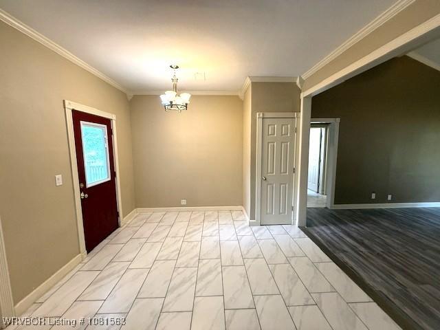 1434 W College St, Ozark, AR 72949 - unfurnished room with crown molding, a chandelier, and baseboards