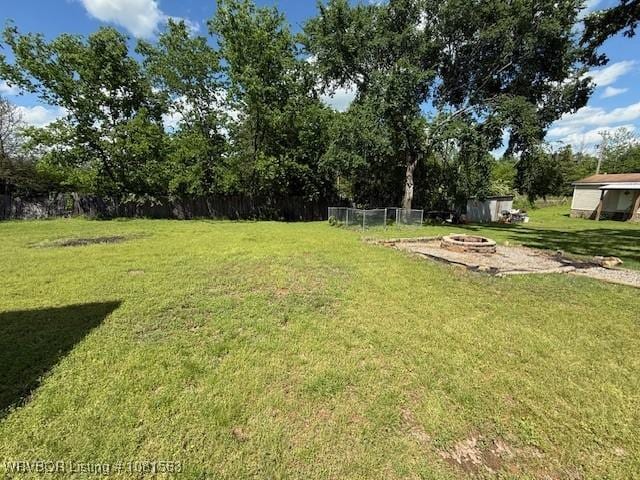 1434 W College St, Ozark, AR 72949 - view of yard featuring a fire pit and view of wooded area