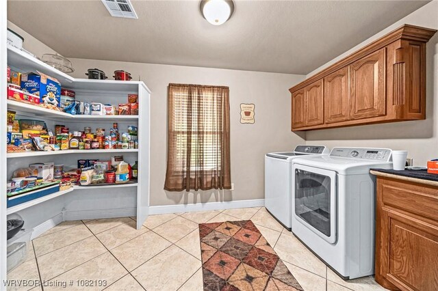 479872 E 1080th Rd, Muldrow, OK 74948 - washroom featuring washer and dryer, light tile patterned floors, and cabinet space