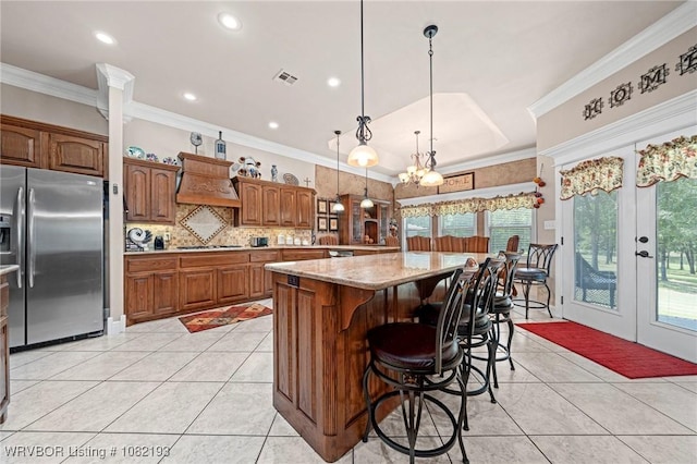 479872 E 1080th Rd, Muldrow, OK 74948 - kitchen with stainless steel appliances, premium range hood, light tile patterned flooring, tasteful backsplash, and a kitchen island