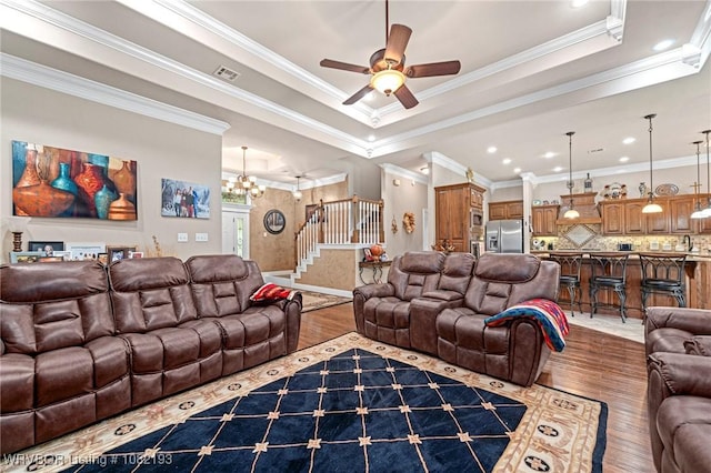 479872 E 1080th Rd, Muldrow, OK 74948 - living area with wood finished floors, stairs, a tray ceiling, ceiling fan, and ornamental molding