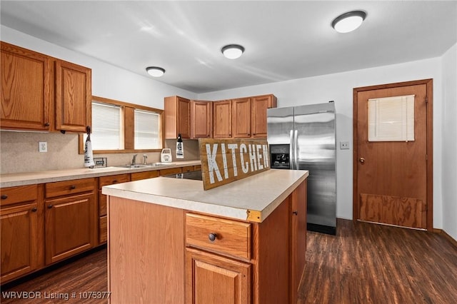 kitchen featuring a center island, sink, tasteful backsplash, dark hardwood / wood-style flooring, and stainless steel fridge with ice dispenser