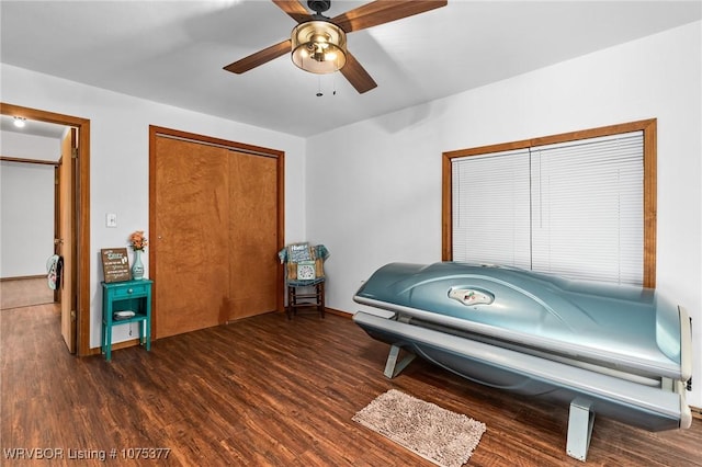 misc room with ceiling fan and dark hardwood / wood-style flooring