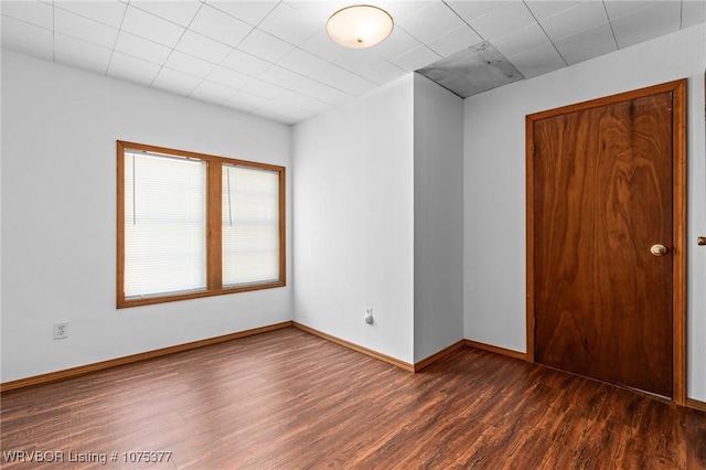 empty room with dark hardwood / wood-style floors