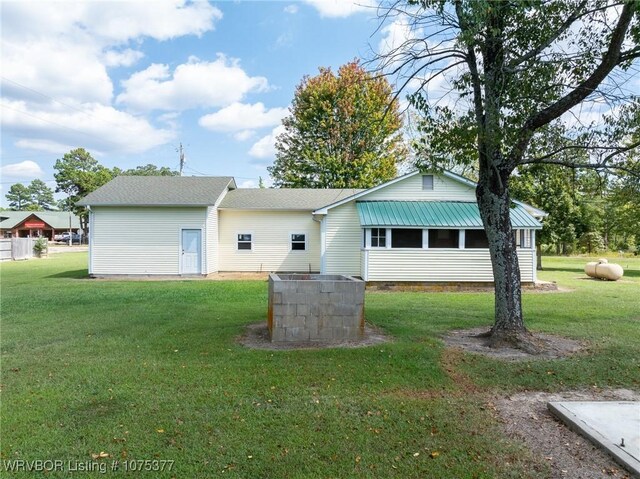 rear view of property with a yard