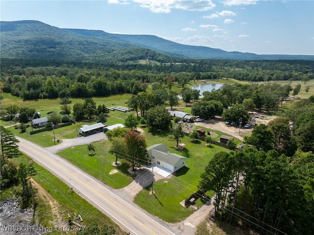 birds eye view of property with a water and mountain view