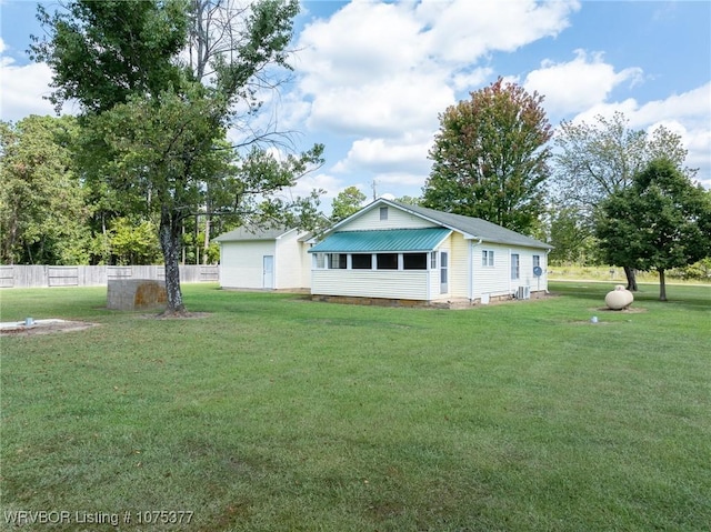 back of property with a lawn