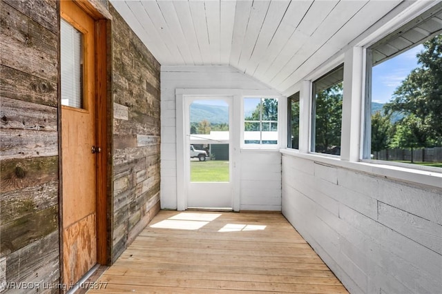 unfurnished sunroom featuring wooden ceiling and vaulted ceiling